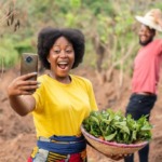 excited african farmers checking a phone see exciting news